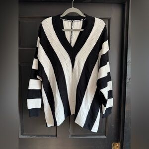 Bold Black and White V-Neck Sweater with Striking Stripes